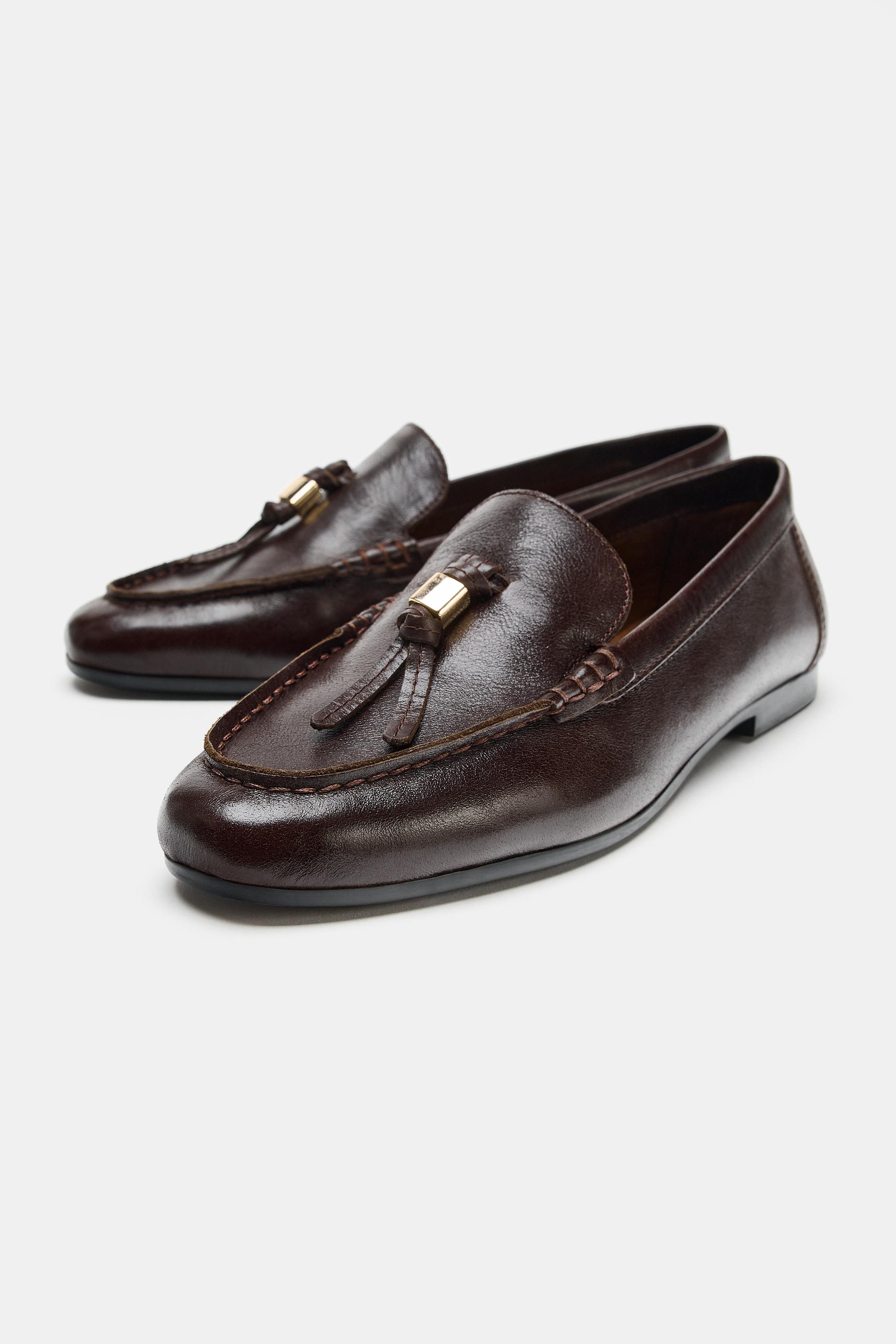 MOCASSINS EN CUIR À POMPONS
