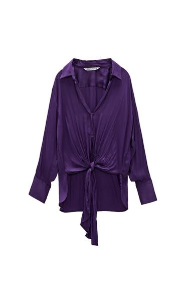 Purple satin long-sleeve shirt against a white background. It features a lapel collar, V-neckline and a knot on the front hem.