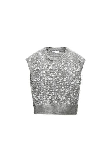 Front view of a gray vest with floral sequins.