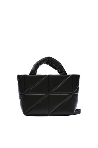 Black quilted bag with a geometric triangle design, short handles, and a white background.