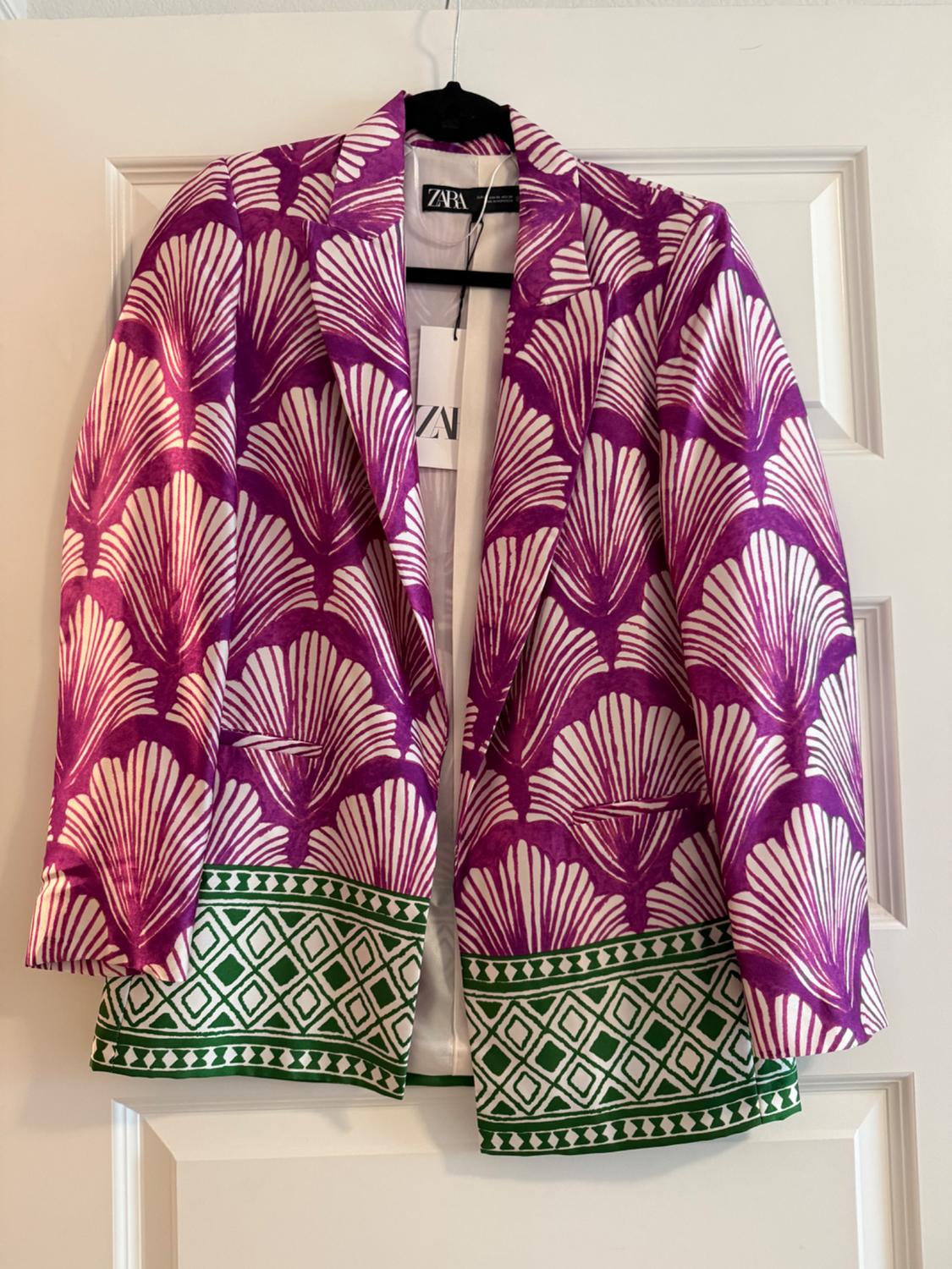 Printed blazer with purple and white fans, and a green geometric hem. ZARA tag visible. Hanging on a white door.