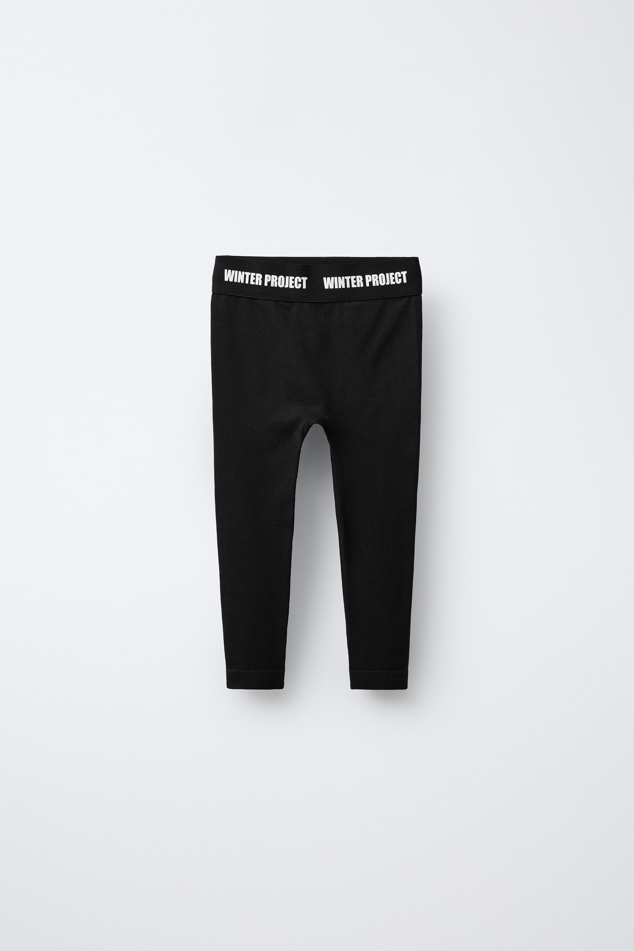EMBOSSED TEXT RIBBED LEGGINGS