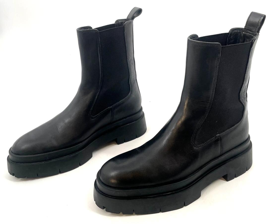 Pair of black Chelsea boots with elastic side panels, a rear pull tab, and a chunky lug sole on a white background.