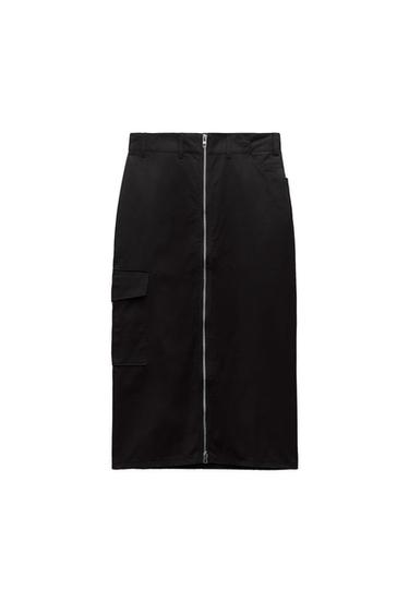 Front view of black skirt with central zip and side flap pocket.