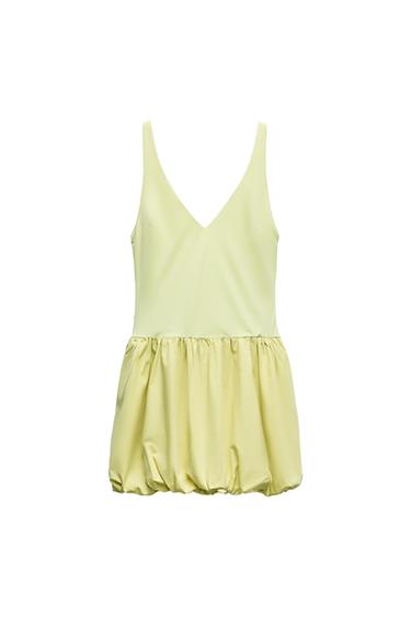 Pastel yellow sleeveless short dress with a V-neckline and a bubble-style balloon skirt, set against a white background.