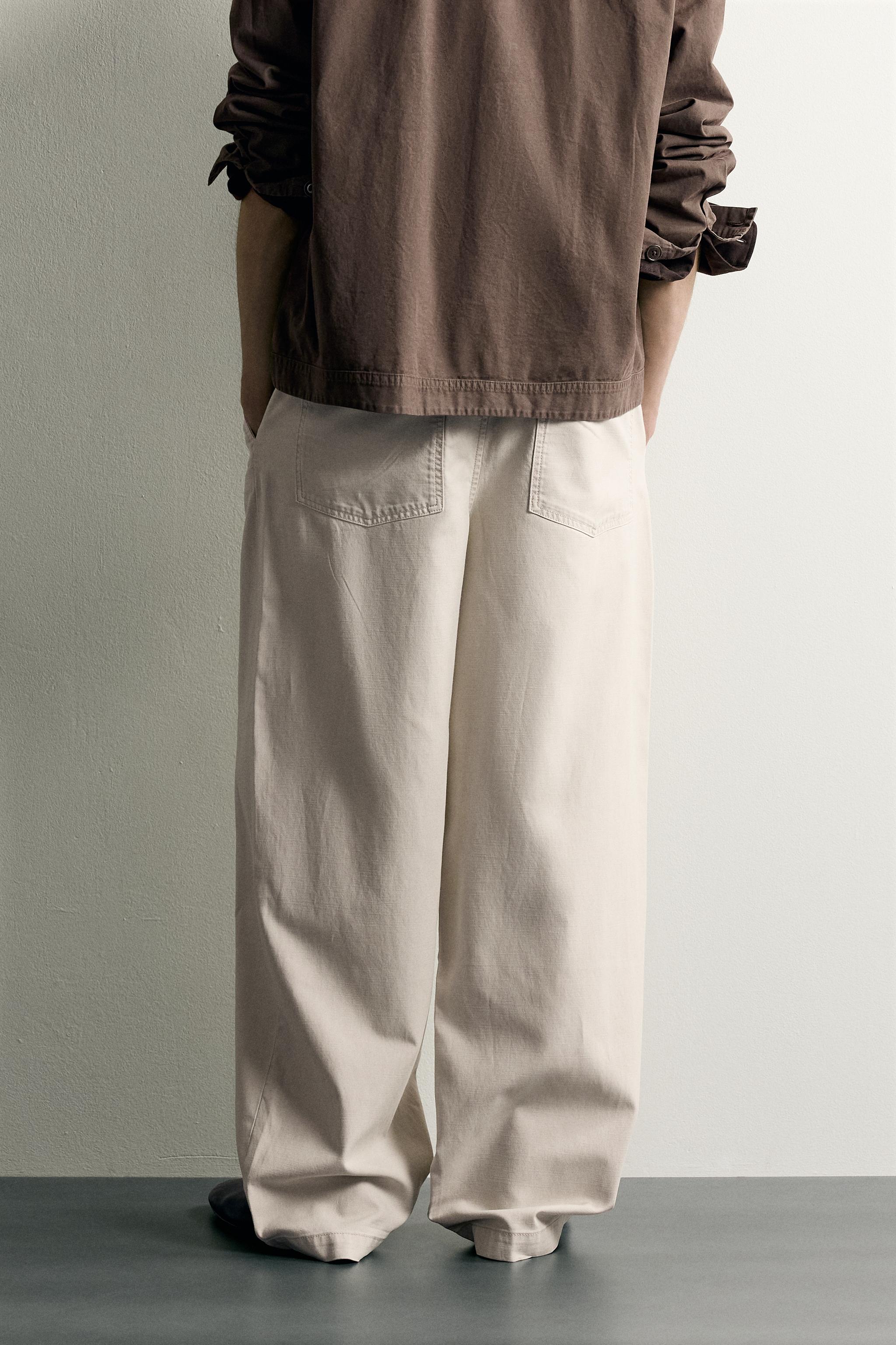 PANTALON COUPE DÉCONTRACTÉE À PLIS AVEC CEINTURE