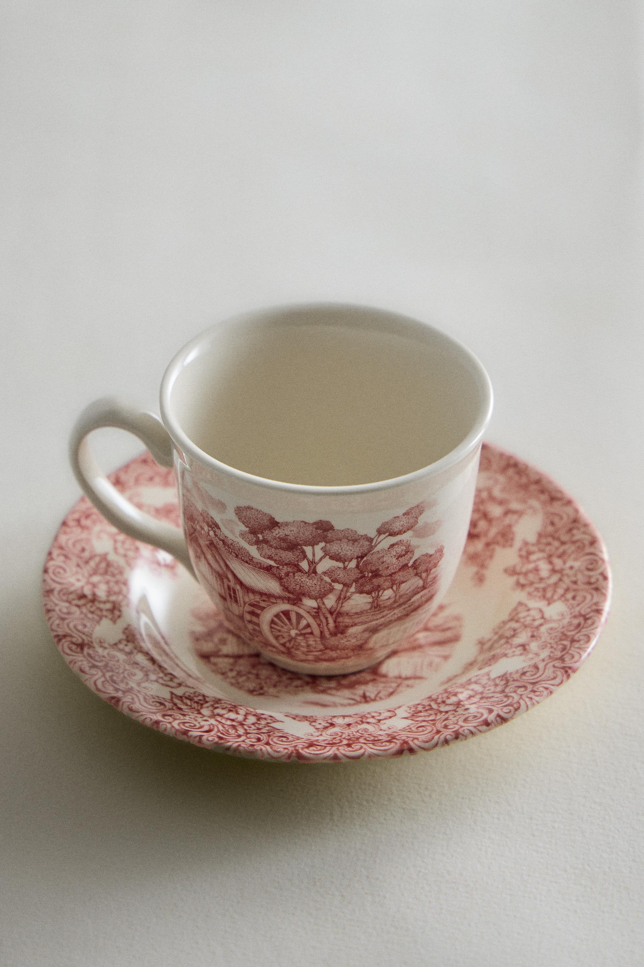 FLORAL AND LANDSCAPE EARTHENWARE COFFEE CUP AND SAUCER SET