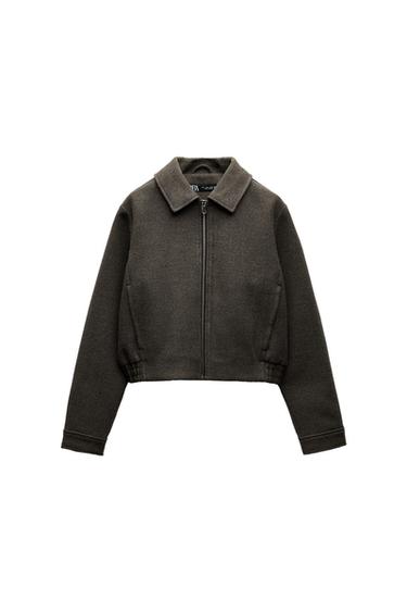 Front view of a brown jacket with a zip and classic collar.