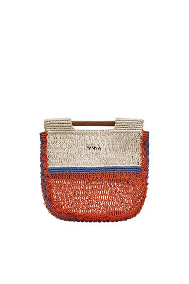 Woven bag with wooden handles, designed in cream, blue, and orange colors. Visible text: "OZAY". White background.