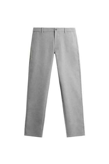 Front view of grey trousers with side pockets, button and zip fastening, and belt loops.