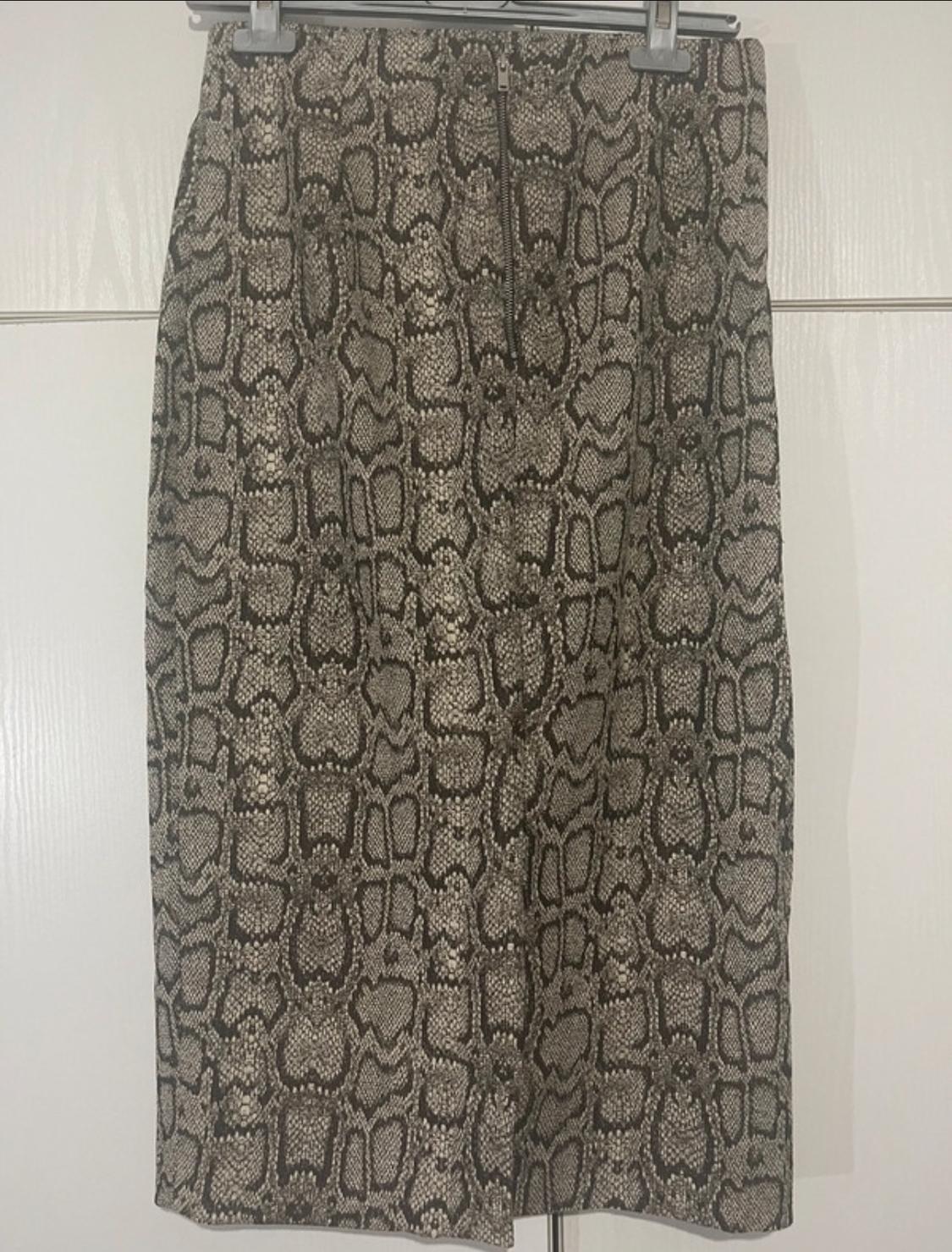 Front view of a printed skirt with a snake print design in brown and beige tones.