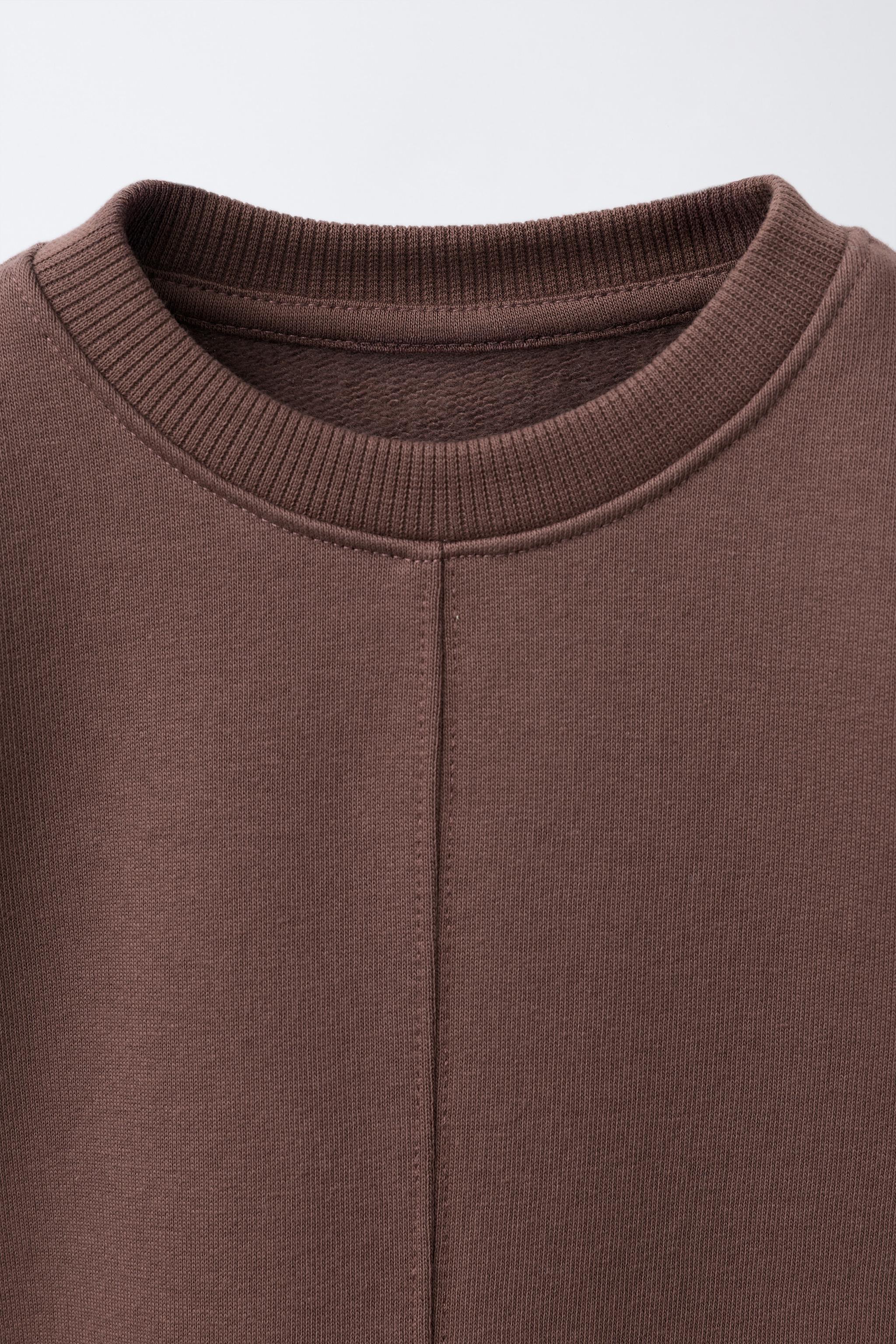 RAISED TEXT SWEATSHIRT