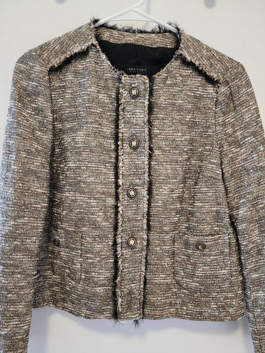 Front view of a textured jacket with buttons and front pockets.