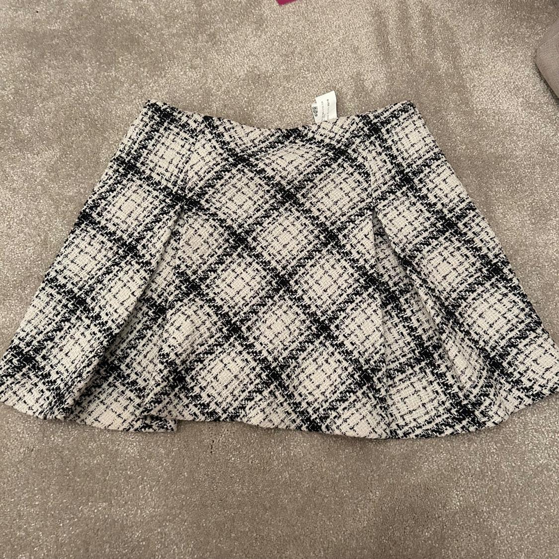 Front view of a black and white checked skirt.