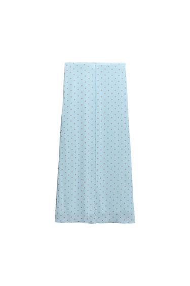 Light blue maxi skirt with a print of small brown polka dots on a white background.