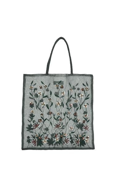 Front view of tote bag with floral embroidery in shades of green and brown.