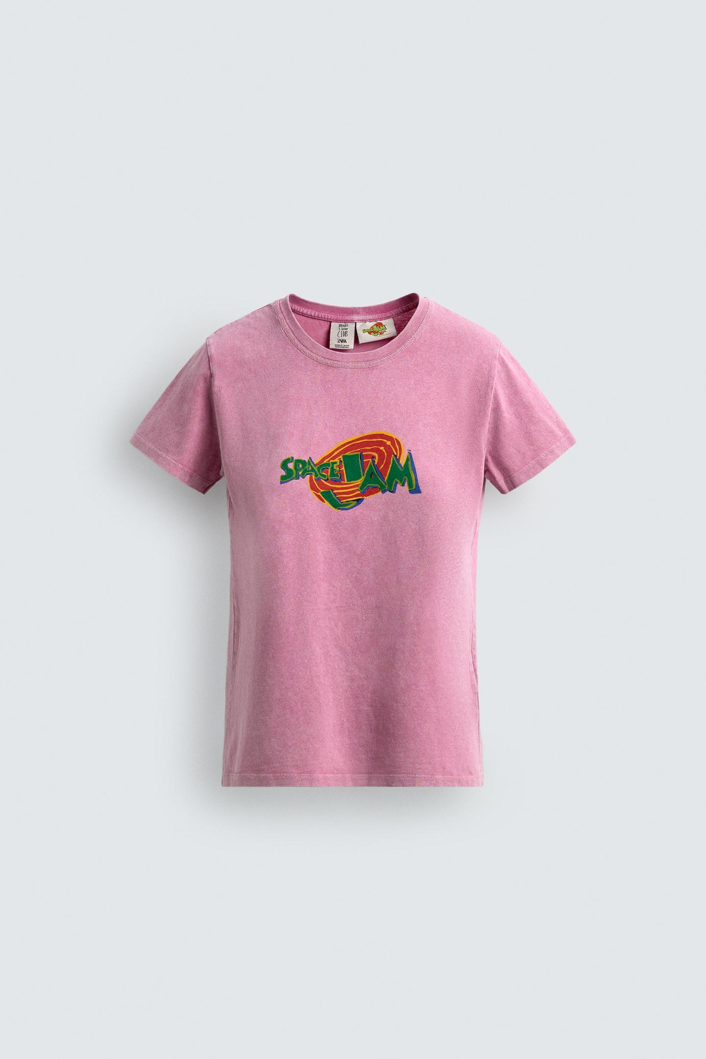 Front view of a pink crewneck, short-sleeve t-shirt. Space Jam graphic on the front in vivid colors.