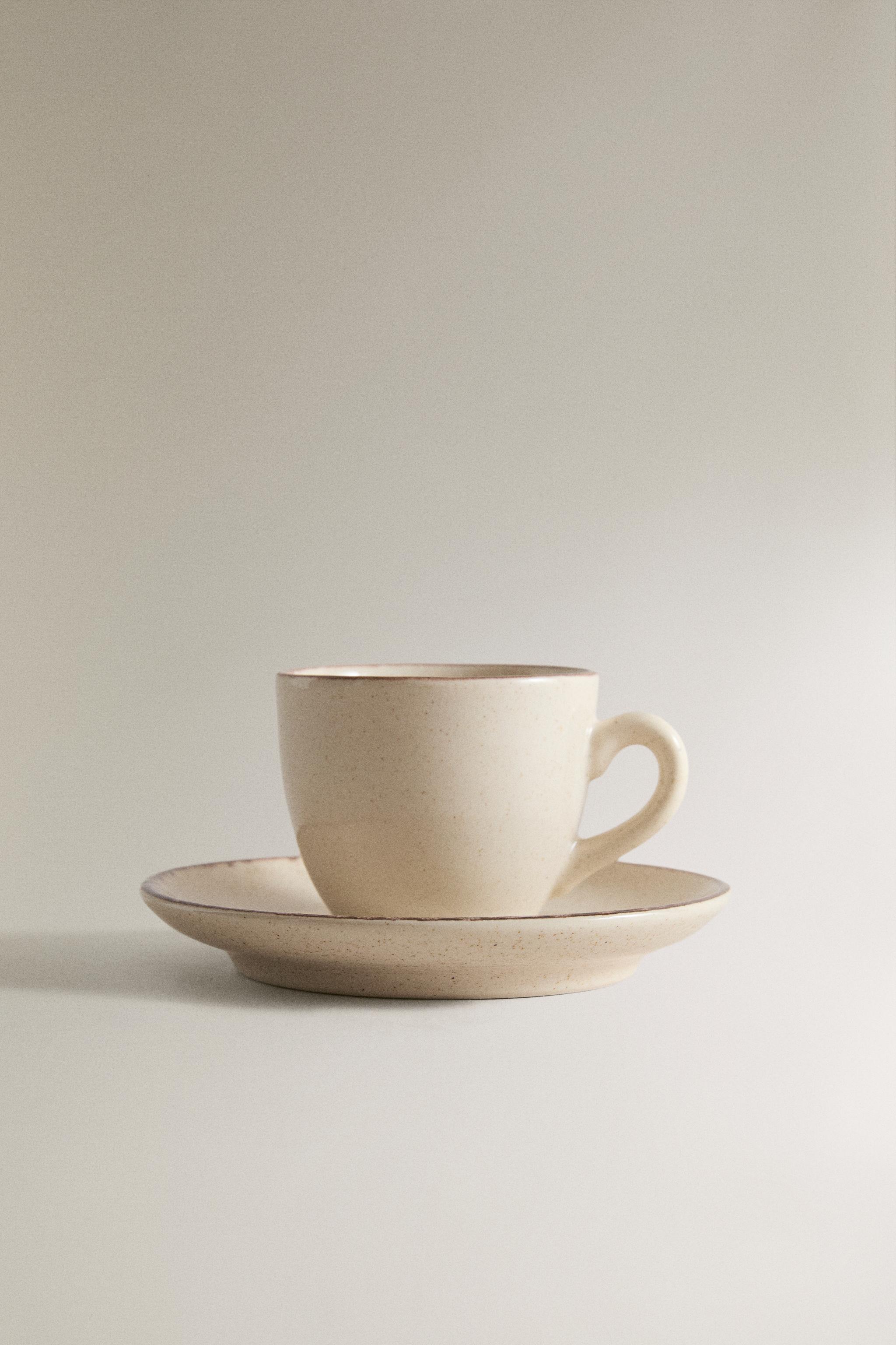 STONEWARE COFFEE CUP AND SAUCER WITH DISTRESSED RIM