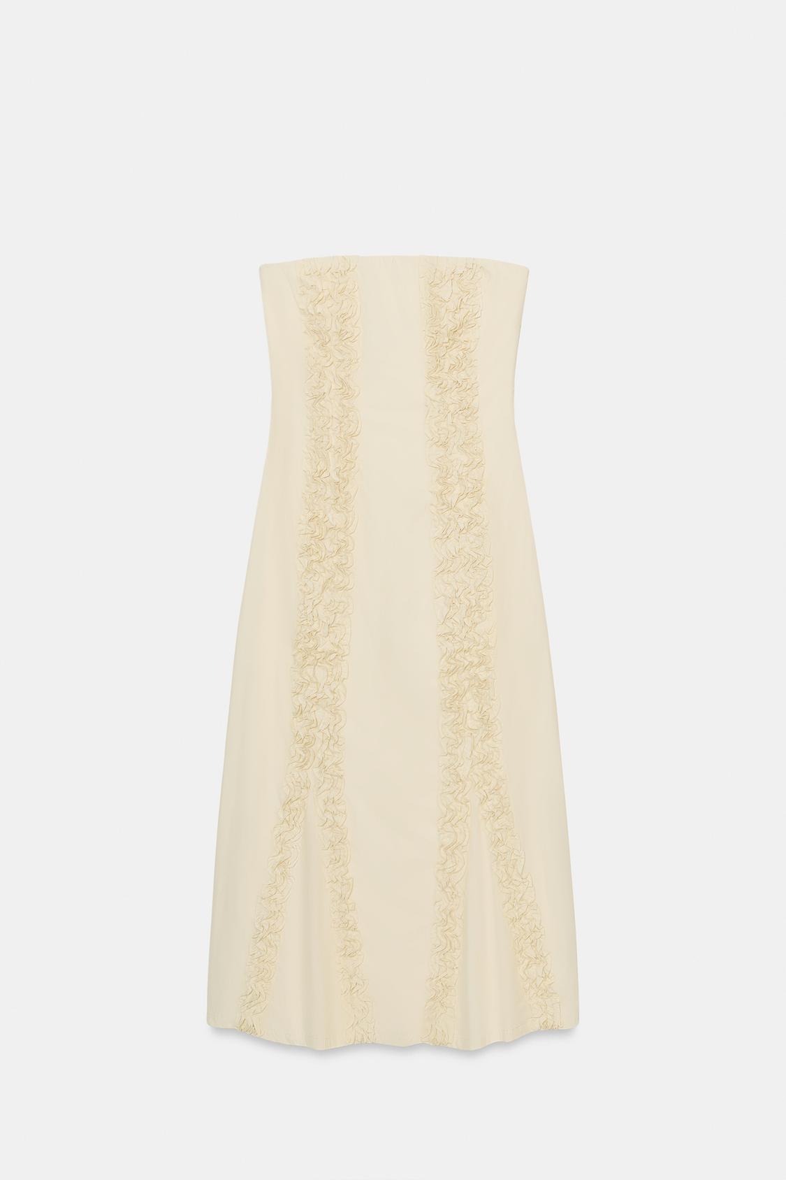 Front view of an ivory, sleeveless, midi-length bandeau dress with embossed ruffles and a concealed side zip.