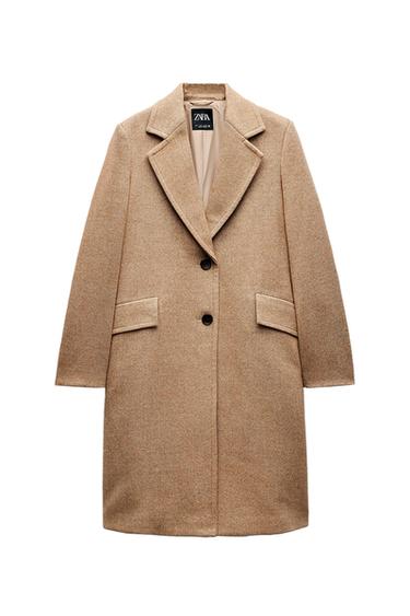 Front view of camel coat with lapels, two buttons, and flap pockets.
