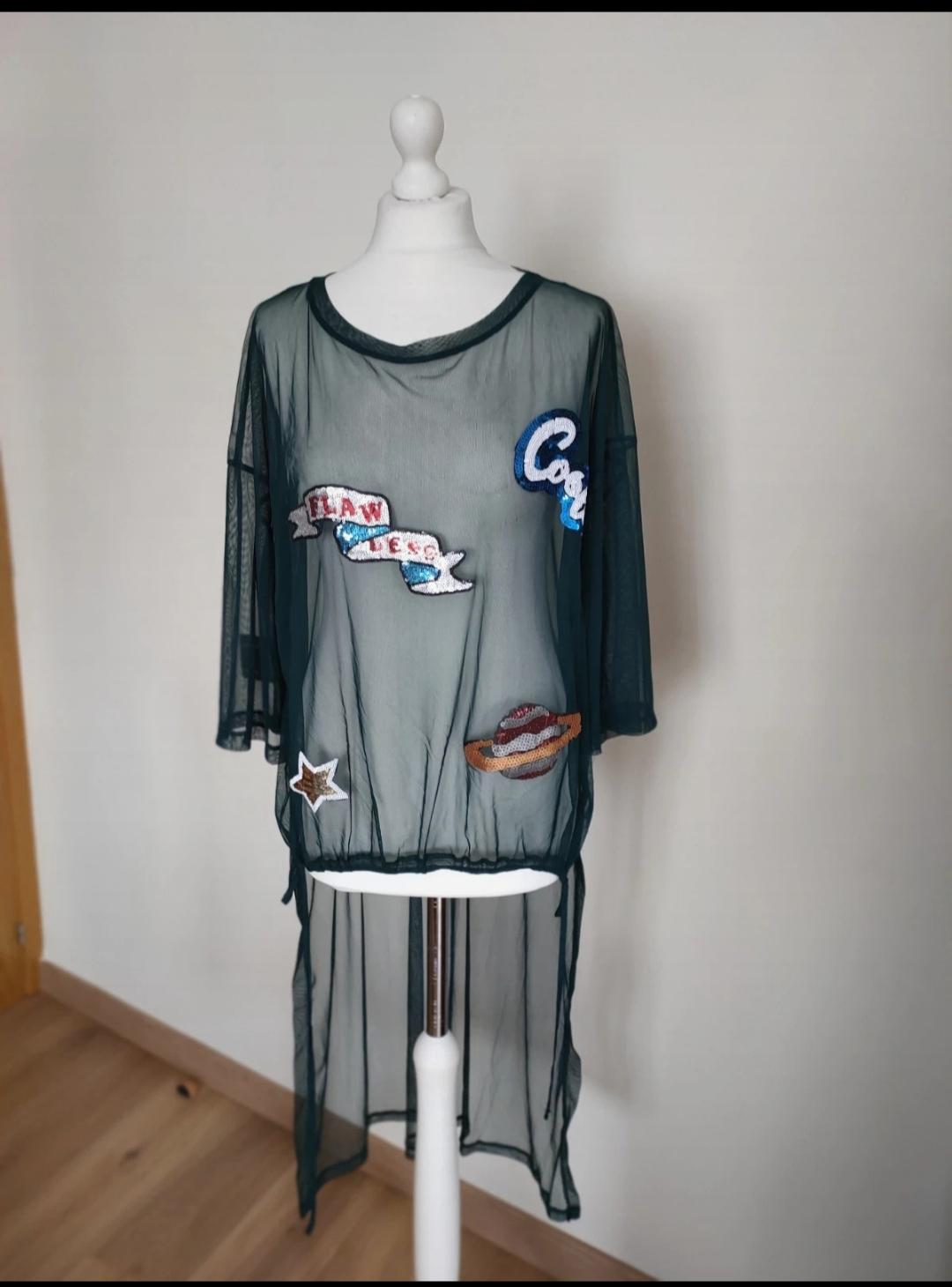 Front view of a black sheer blouse with 'FLAWLESS', 'COOL', star and planet text patches.