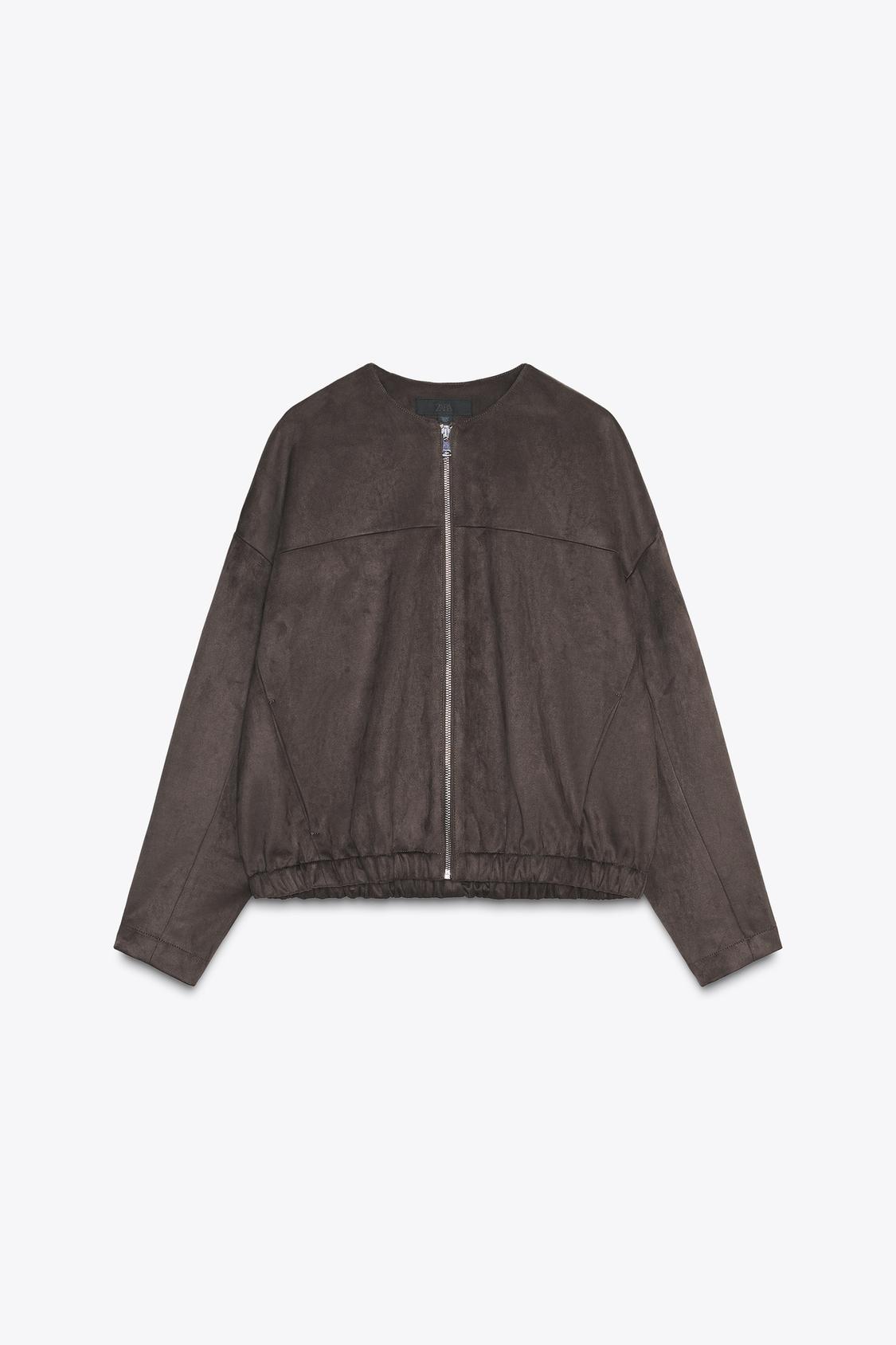 Front view of a raw jacket with a round neck, long sleeves, front pockets and a front zip fastening. Elasticated hem.