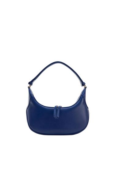 Blue crescent-shaped shoulder bag with a short handle and double front zip detail on a white background.