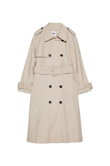 Front view of a beige double-breasted coat with an adjustable belt and side pockets.