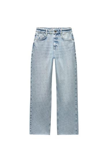 Front view of light blue jeans with front pockets and button.