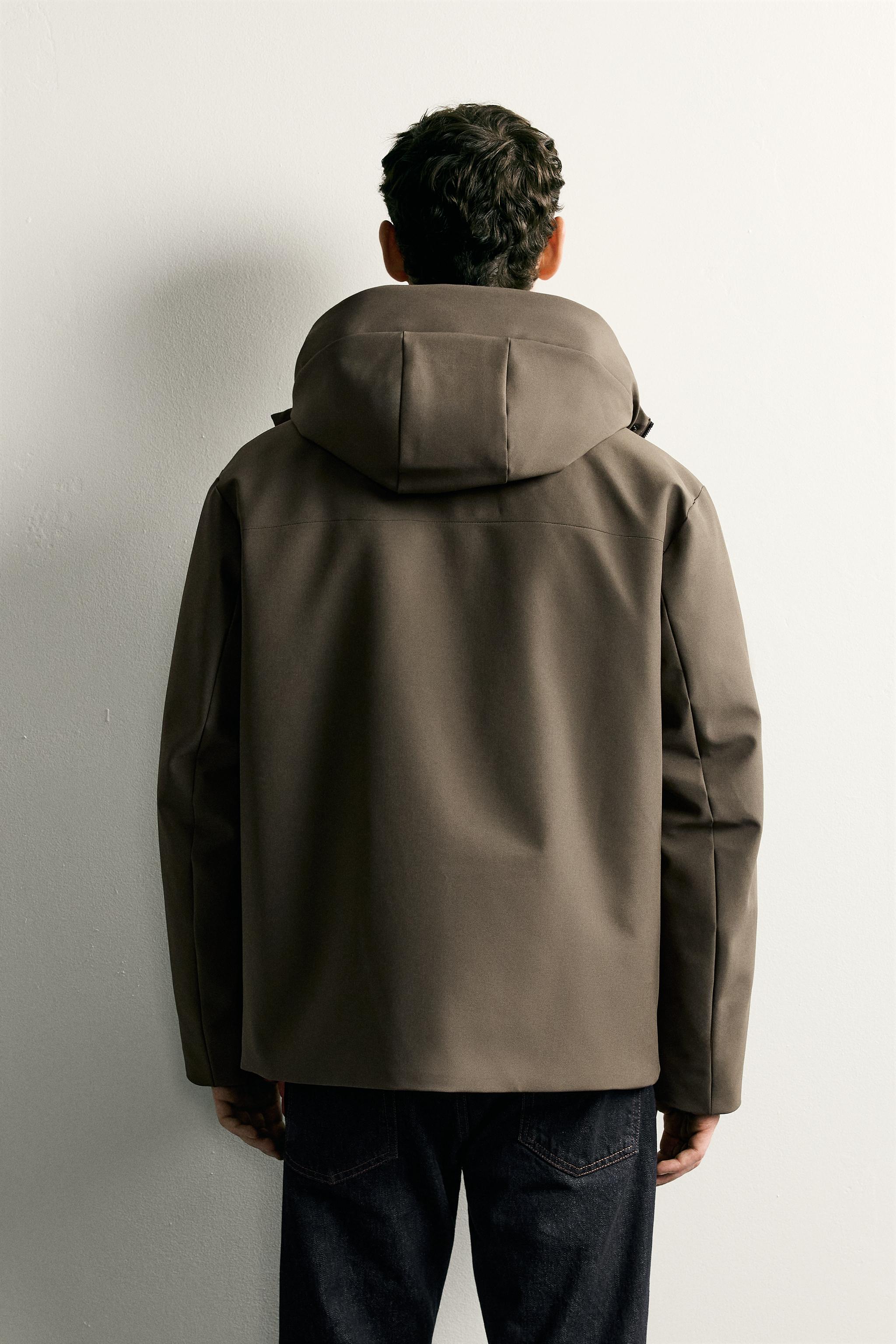 BLOUSON TECHNIQUE À CAPUCHE DÉPERLANT