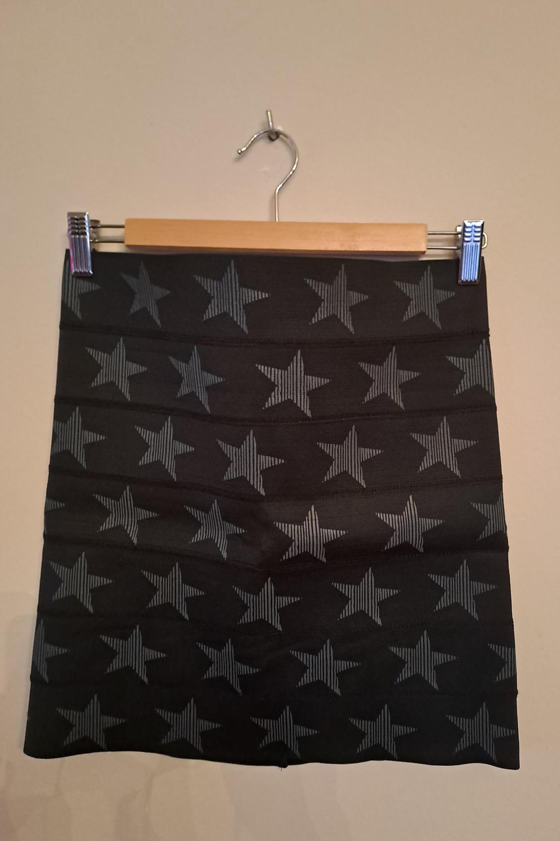 Front view of a black skirt with a grey star print.