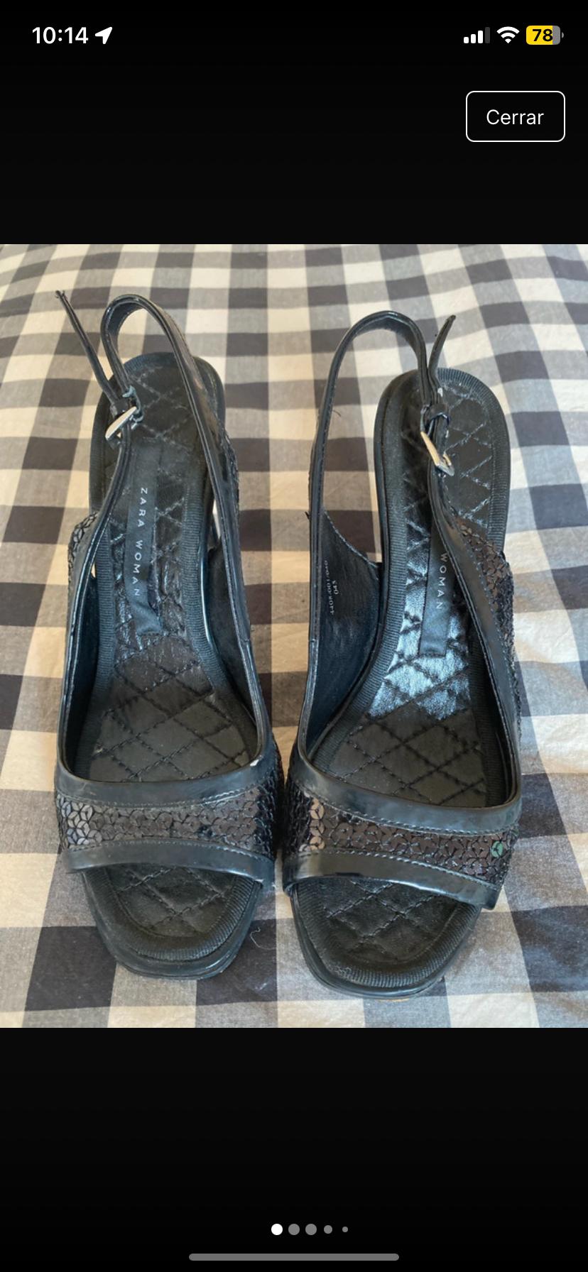 Front view of black strappy sandals with a padded insole featuring 'ZARA WOMAN' text.