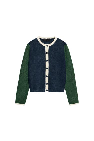 Front view of a colour block knitted jacket with a round neck, long green and blue sleeves, and a front fastening with dark buttons.