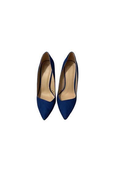 Navy blue high heels with pointed toes, seen from above on a white background. Visible beige interior.