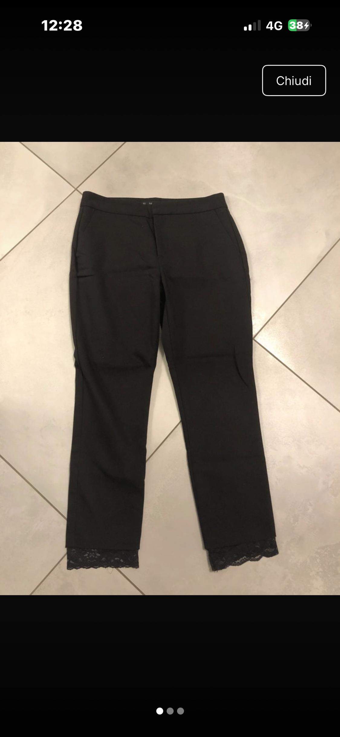 Black trousers with a lace hem on a tiled floor. Visible text: 12:28, 4G, 38, Close.