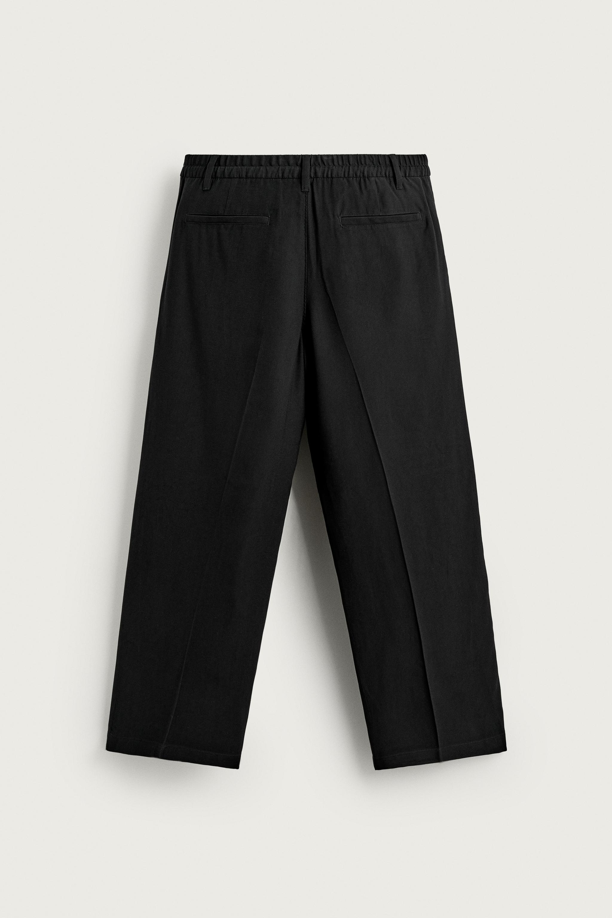 FLOWY RELAXED FIT PLEATED PANTS