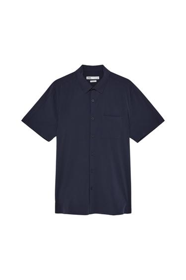 Navy blue short-sleeve button-down shirt with chest pocket. Visible label on the neck with the text "Zara".