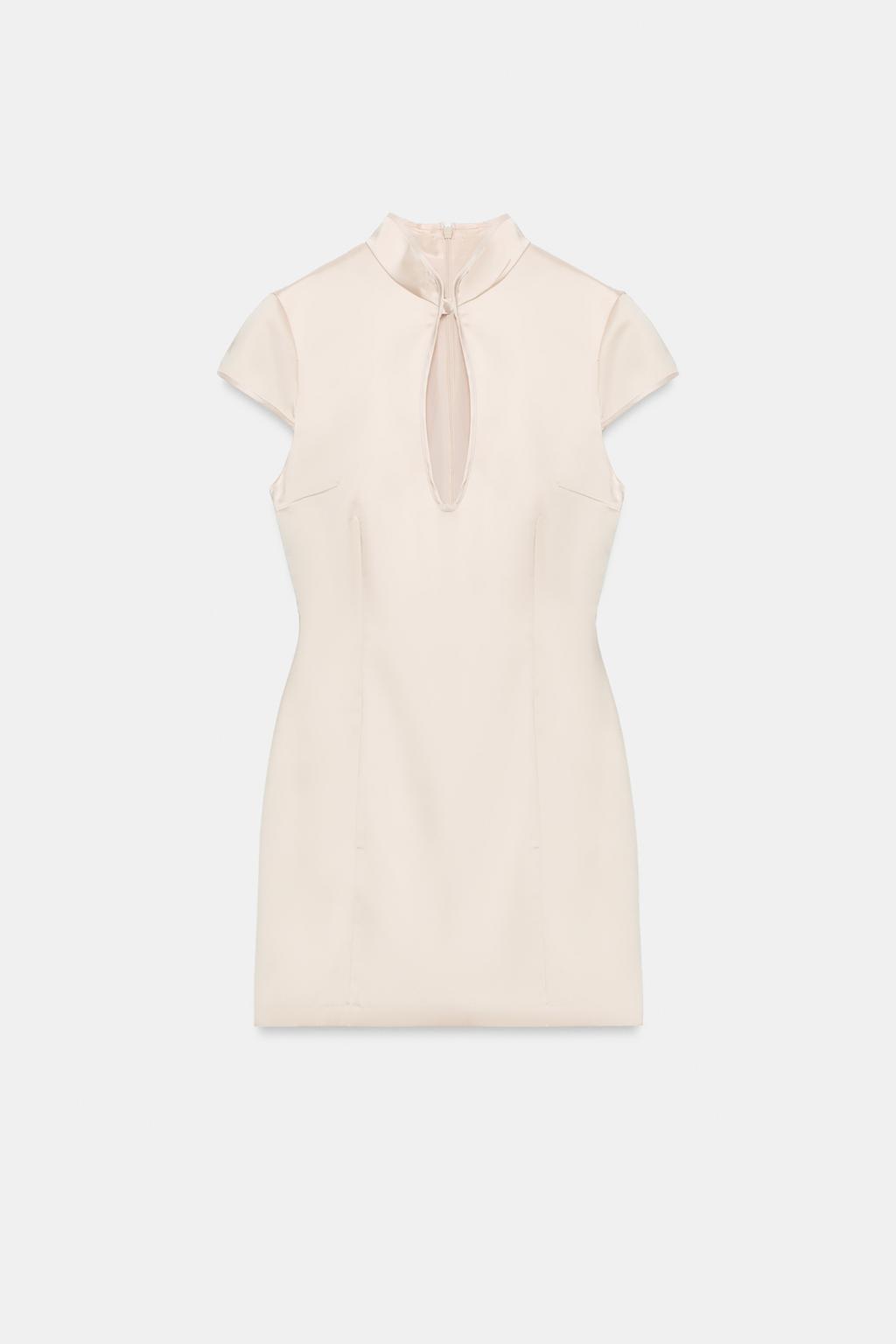 Front view of a light beige short dress. It features a high neck with a tear-drop opening on the chest, short sleeves, and vertical seams.