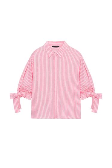 Front view of a pink shirt with white stripes, shirt collar, short sleeves with ties, and a hidden button front closure.