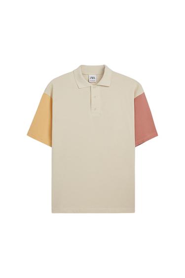 Beige polo shirt with yellow and pink sleeves. Visible label with "ZARA" text.