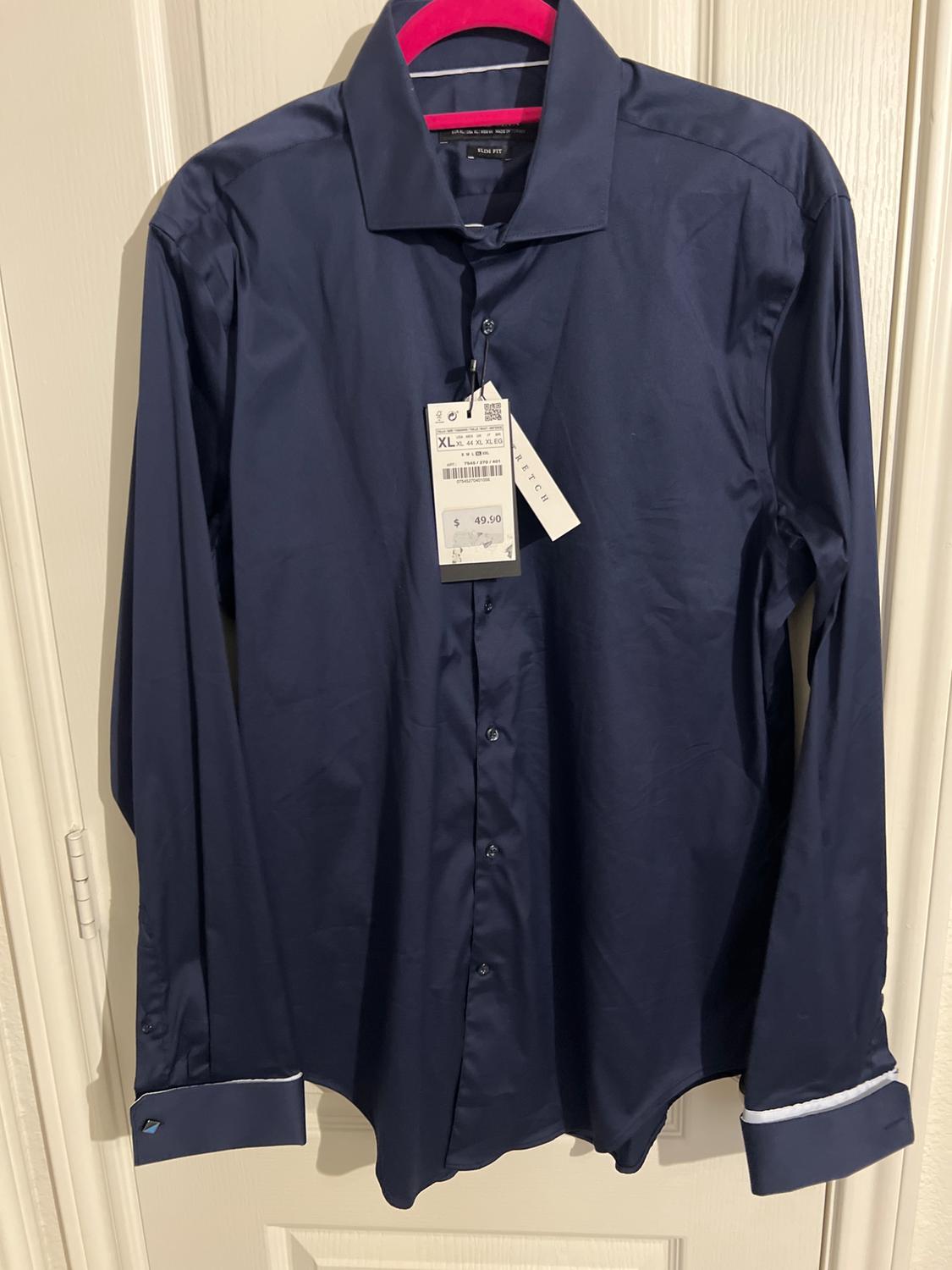 Blue long-sleeved shirt hanging on a pink hanger. Visible tag with price of $49.90 and size XL. White door in background.