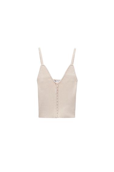 Front view of a beige top with thin straps and a V-neck.