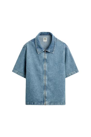 Light blue denim shirt with front zip and short sleeves. Visible label with the text "ZARA".