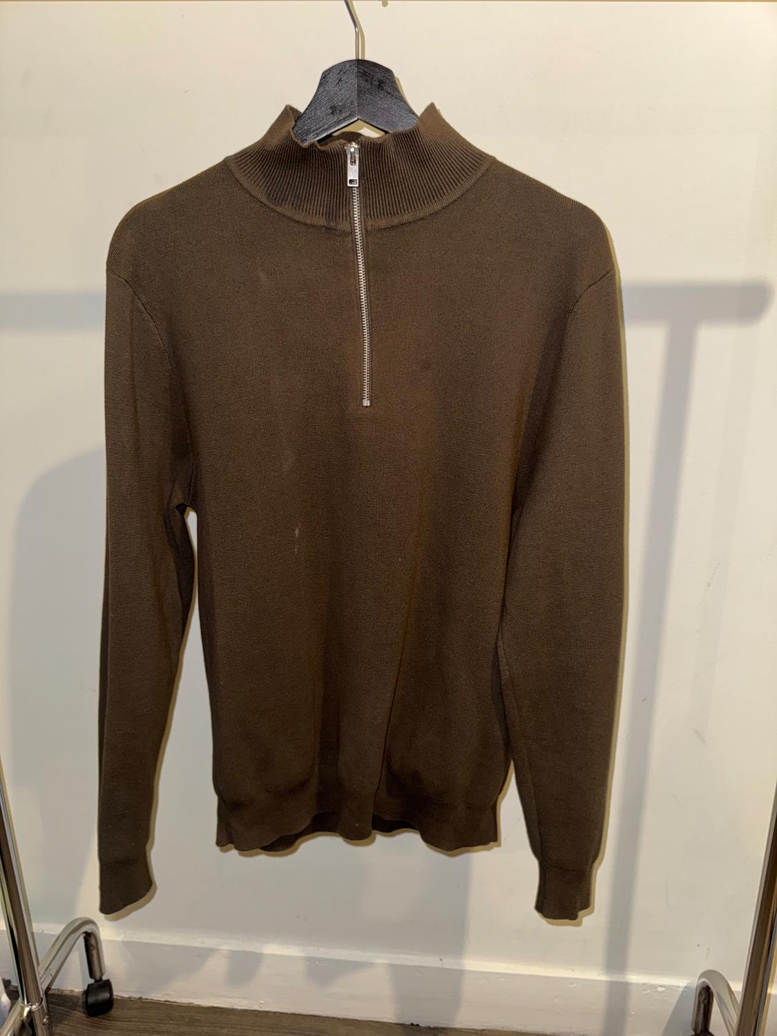 Brown long-sleeved jumper with a zip-up neck, hanging on a black hanger against a white background.