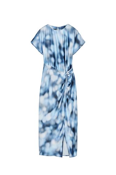 Front view of blue dress with abstract print, short sleeves and knot detail at the waist.