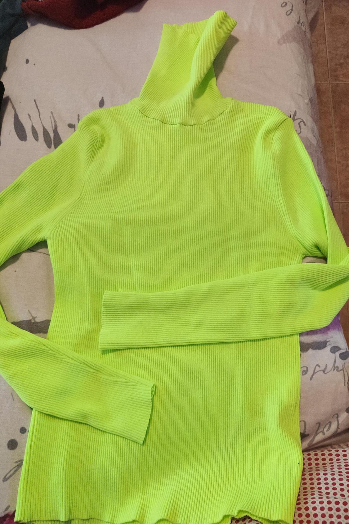 Front view of a neon green roll-neck jumper with long sleeves.