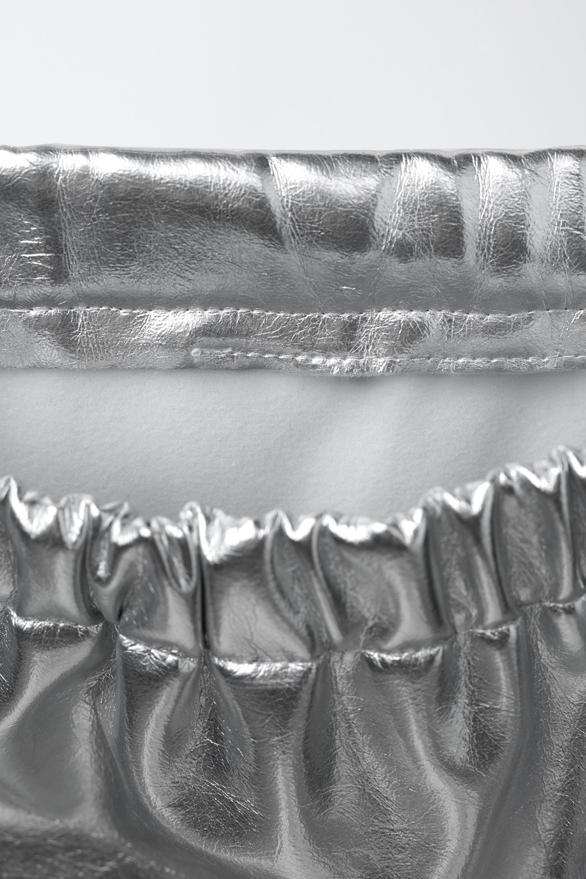 METALLIC SKIRT WITH BOWS