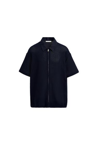 Front view of a navy blue shirt with zip fastening and classic collar.