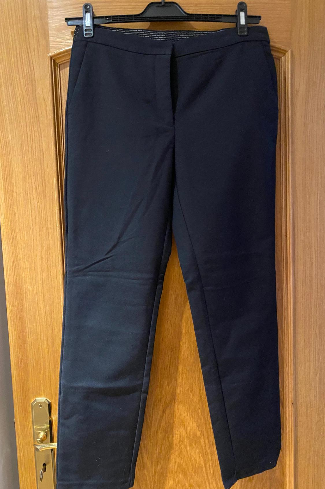 Front view of black trousers with side pockets
