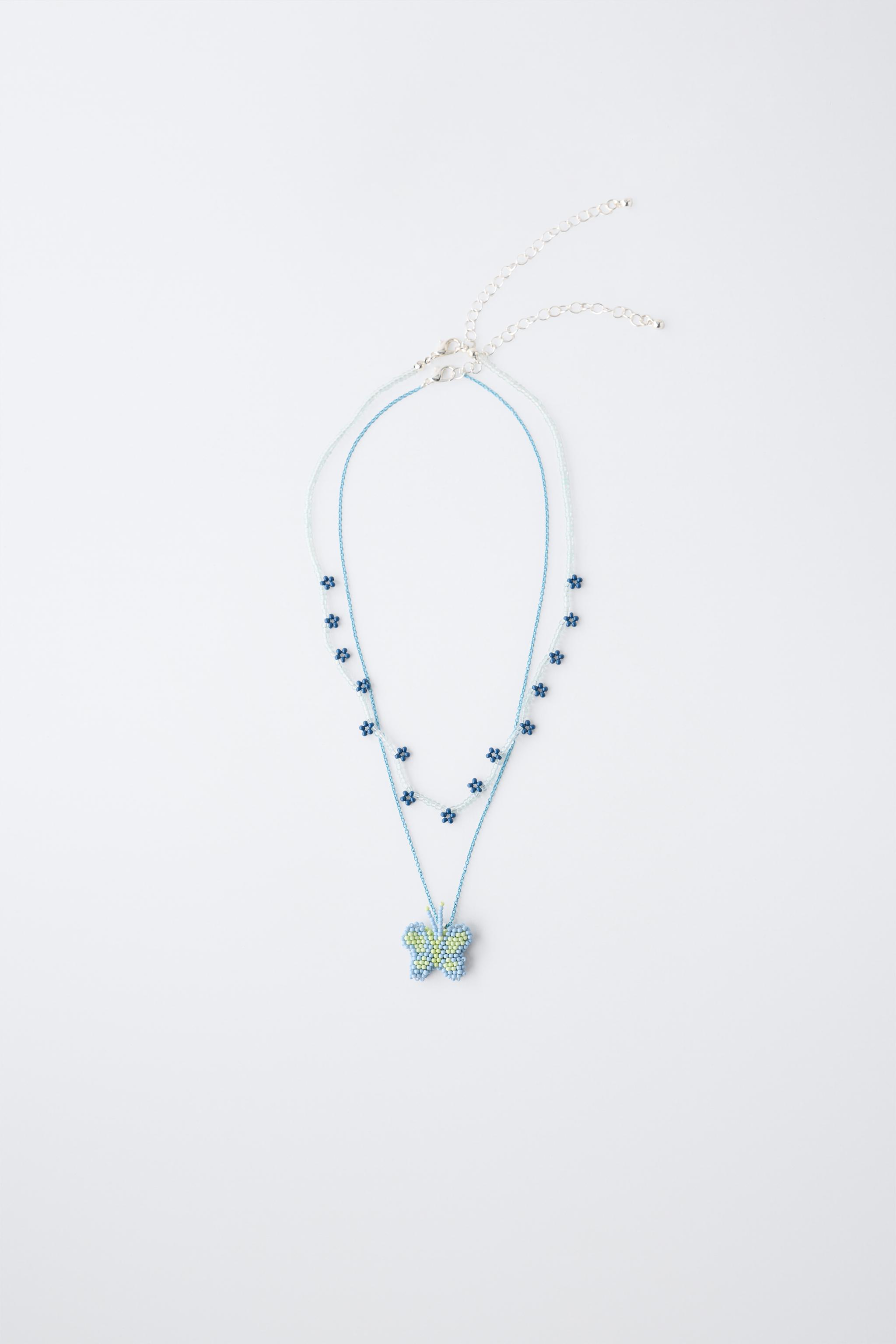 LOT DE DEUX COLLIERS FANTAISIE PAPILLON ET FLEURS